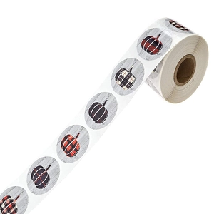 Halloween pumpkin stickers with grey wood grain and checkered patterns on a roll