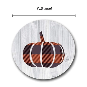 1.5 inch Halloween pumpkin stickers with orange buffalo plaid on white wood background