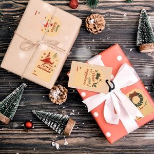 Christmas kraft gift tags with Santa and tree motifs on a festive wood background