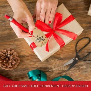 Christmas tree kraft paper stickers on gift boxes with red ribbons and pine cones
