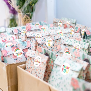 Rainbow Thank You stickers on floral gift bags for birthday parties and baby showers