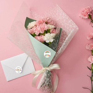 Close-up of rainbow birthday thank you stickers on floral gift wrap and envelopes
