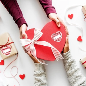 Vue de dessus d'un coffret cadeau rouge en forme de cœur avec ruban de Saint-Valentin