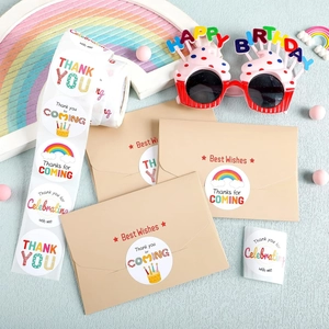 Close-up of rainbow birthday thank you stickers applied on a brown kraft envelope