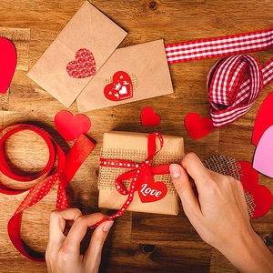 DIY Valentinstag Geschenkset mit roten Herzaufklebern und Bändern auf Holzgrundlage