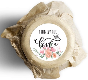 Macro detail of Handmade with Love floral sticker on craft paper gift packaging