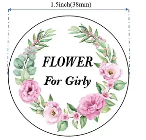 Close-up of circular floral gift sticker with pink roses and Flower For Girly text