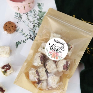Detail of handmade nougat in kraft paper packaging with floral handmade with love sticker