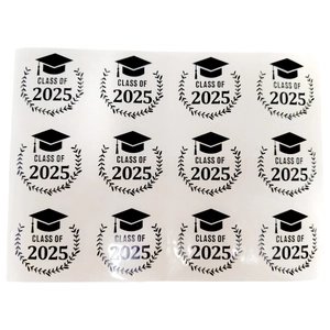 Close-up of 2025 graduation cap stickers with laurel wreaths for party favors