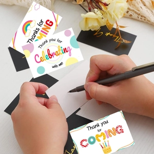 Rainbow and polka dot Thank You For Coming cards set on white wooden background
