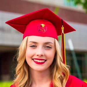 Detailed close-up of Class of 2025 gold foil print on a red graduation cap and gown