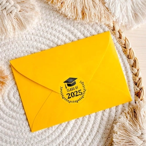 Class of 2025 graduation cap sticker with gold foil on a yellow envelope for ceremony gifts