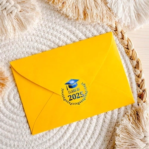 Detail of Class of 2025 graduation sticker with gold foil on a yellow envelope seal