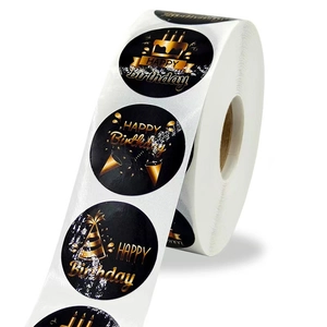 Detailed macro view of black Happy Birthday stickers with metallic gold foil cake patterns
