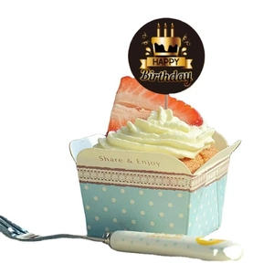 Close-up of blue polka dot cupcake liner with Happy Birthday topper and silver dessert fork