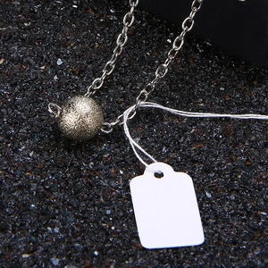Minimalist necklace with a matte textured metal sphere pendant on a silver O-chain