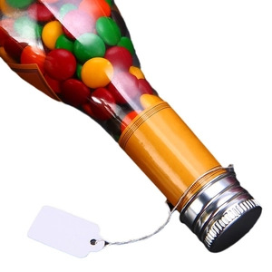 Colorful candies in a clear bottle with silver cap and white hanging price tag