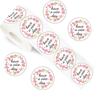 Detail of round cherry blossom stickers roll with black Have a Nice Day printed text