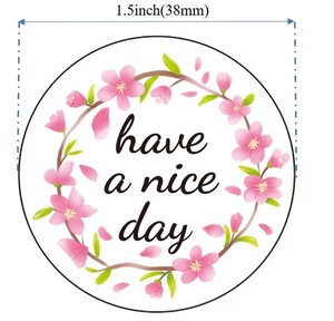 Close-up of 1.5 inch pink cherry blossom sticker with Have a Nice Day greeting