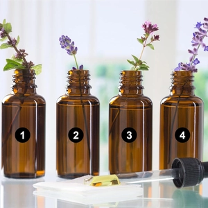 Detail of amber glass bottles with numbering and high transparency glass dropper set
