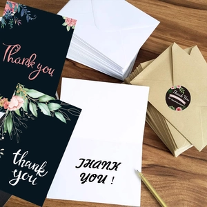 Navy floral thank you card set with envelopes, stickers, and gold pen on wood desk