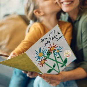 Detail of Happy Mother's Day card with floral design and round decorative sticker