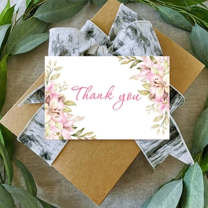 Floral thank you card with envelopes on kraft gift box with greenery and white ribbon