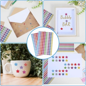 Detail showing colorful glitter star stickers applied on envelopes and mugs for DIY decoration