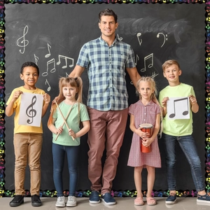 Classroom blackboard decorated with musical note borders featuring a teacher and students