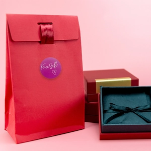 Red paper jewelry gift bag and box set with purple Free Gift sticker and ribbon
