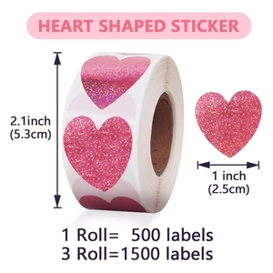 Detail of three rolls of pink glitter heart shaped stickers showing 1 inch diameter size