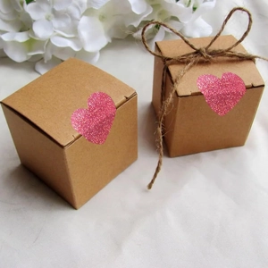 Brown kraft paper gift boxes with pink glitter heart stickers and natural jute rope decor