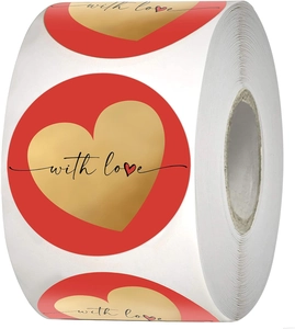 Detail of red circular stickers with gold foil hearts and 'with love' text on a roll