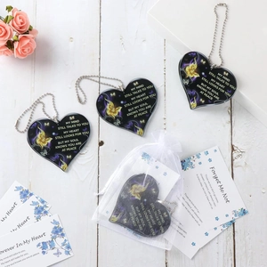 Memorial set with heart pendant and Forget Me Not cards on white wooden background
