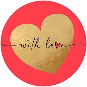 Macro detail of round red gift sticker with gold foil heart and with love script text