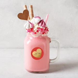 Detail of red circular 'with love' sticker with gold heart on a dessert mason jar