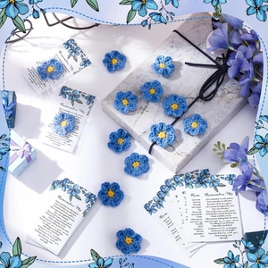 Detail of handmade crochet blue forget-me-not flower on a Remember Me funeral prayer card