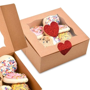 Brown kraft bakery boxes with heart stickers and clear windows showcasing fresh cookies
