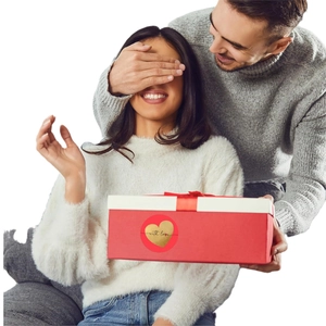Red heart stickers with gold foil on a gift box for Valentine's Day and anniversary