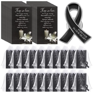 Funeral prayer cards with lily design, memorial ribbons, and white organza gift bags