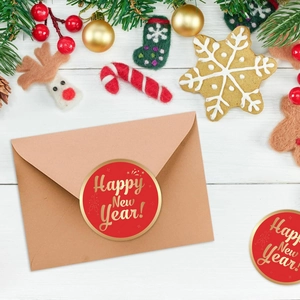 Detail of red Happy New Year stickers with gold foil used for gift envelope sealing