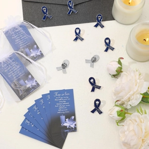 Funeral prayer cards set with blue ribbon pins, memorial poem and organza gift bags