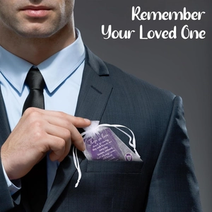 Funeral prayer card with purple poem and white mesh bag in a men's suit pocket
