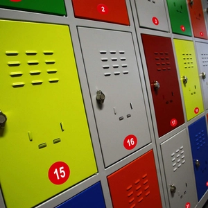 Waterproof PVC numbered stickers 1-50 on colorful metal lockers with ventilation slots