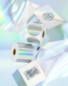 Macro detail of round and rectangular laser thermal stickers with rainbow holographic effect