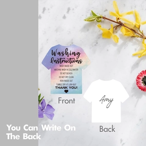 Detail of T-shirt shaped washing instruction cards with space for handwritten names