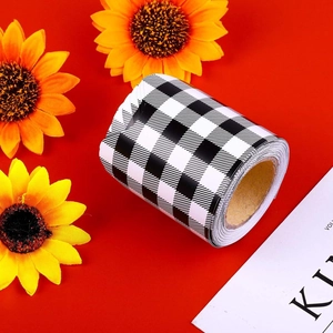 Close-up of black and white checkerboard decorative bulletin border roll on red background