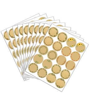Detailed close-up of kraft paper stickers with green botanical wreaths and floral patterns