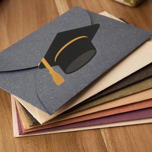 Graduation gift envelopes in vintage colors with a graduation cap sticker on wooden desk