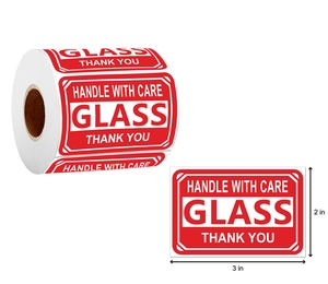 Close-up of 3x2 inch Handle With Care Glass fragile warning labels on a sticker roll